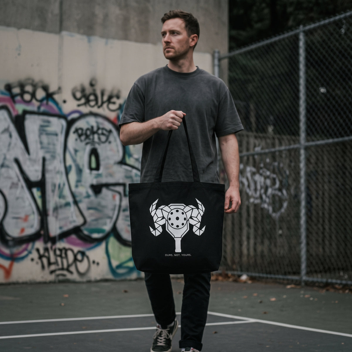 Aries — First Strike tote bag — model carrying the black organic cotton pickleball tote bag
