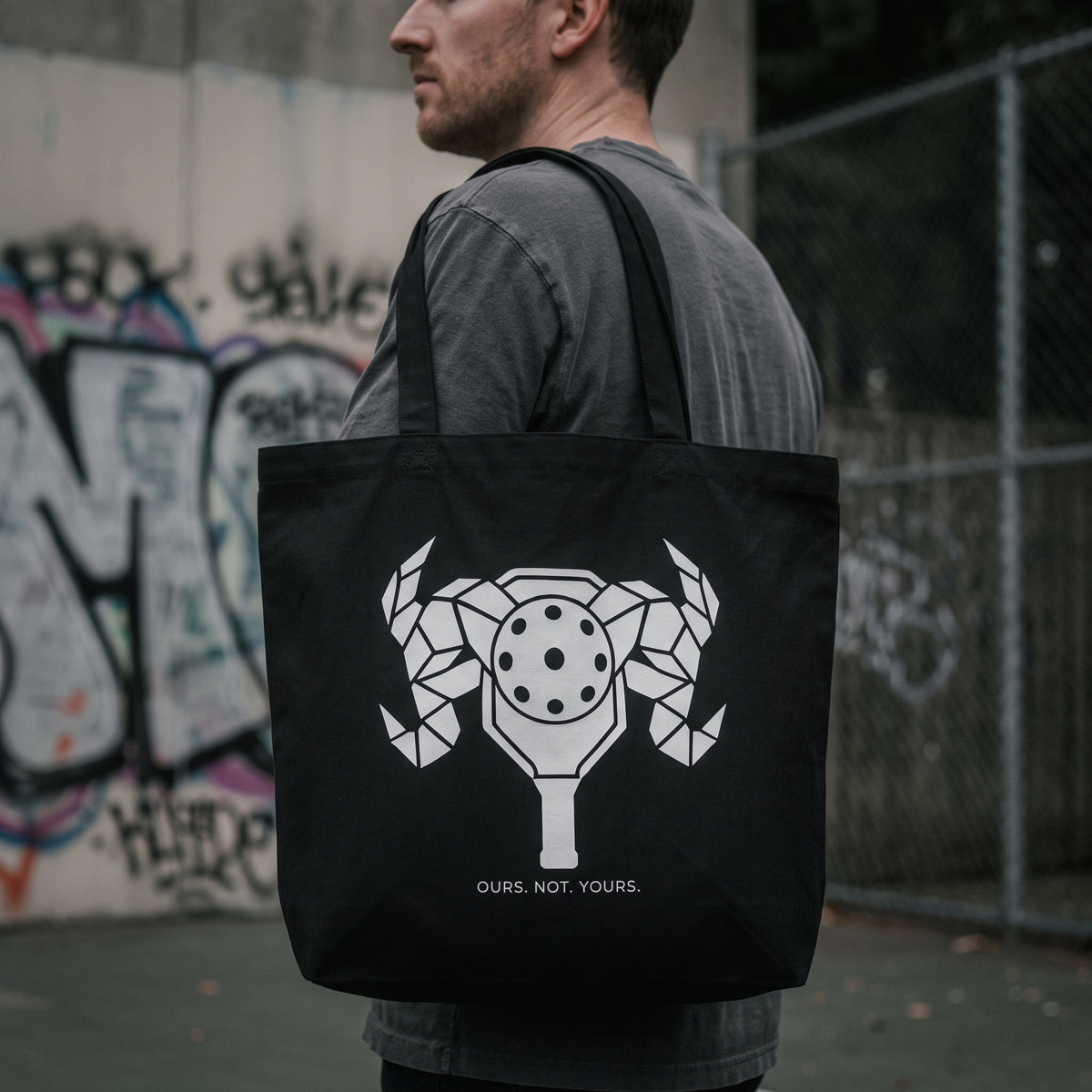 Aries — First Strike tote bag — close-up of the black pickleball tote bag on the shoulder