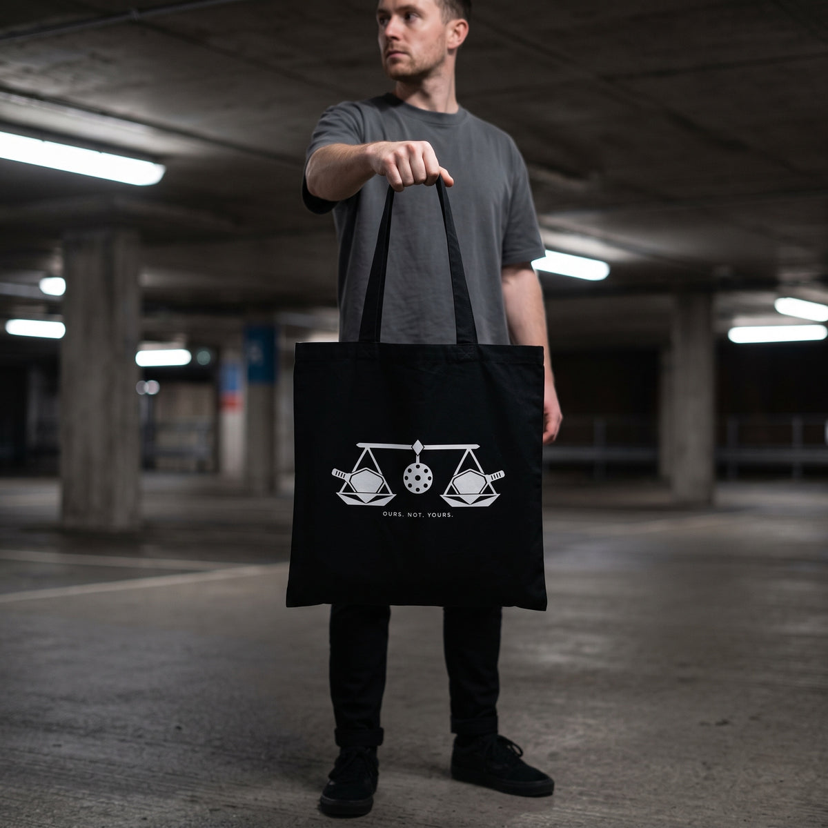 Libra — Balance Under Pressure tote bag — model carrying the black organic cotton pickleball tote bag