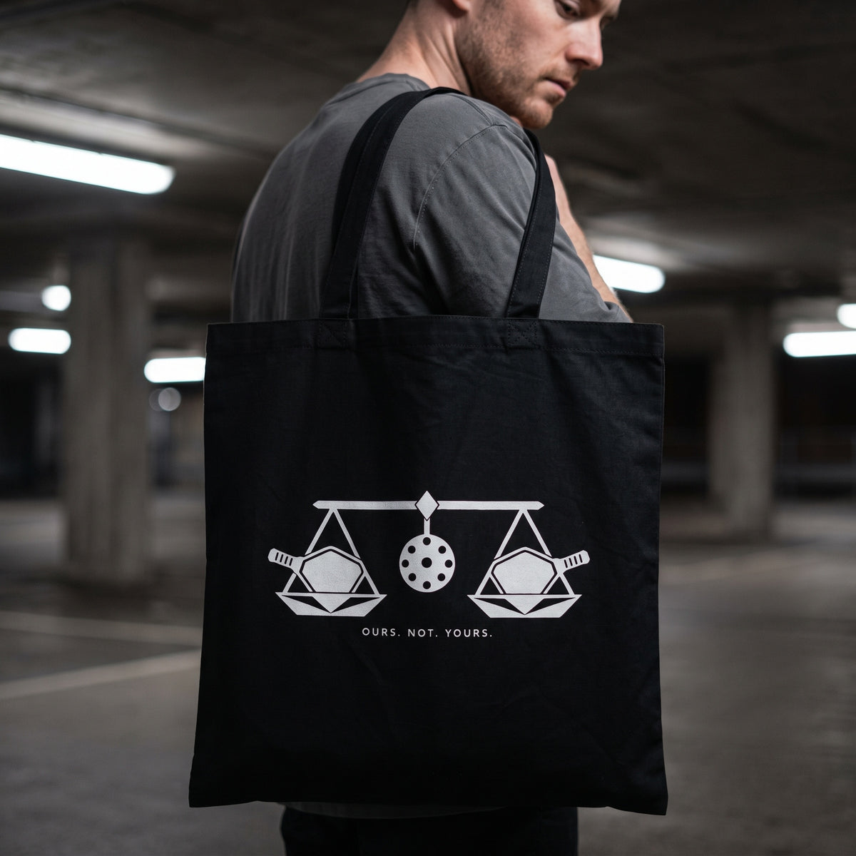 Libra — Balance Under Pressure tote bag — close-up of the black pickleball tote bag on the shoulder