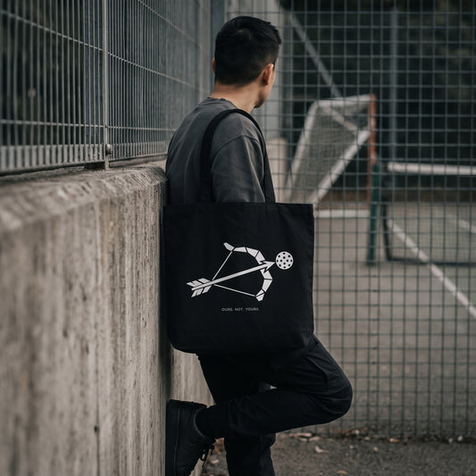 Sagittarius — Target Locked tote bag — model carrying the black organic cotton pickleball tote bag