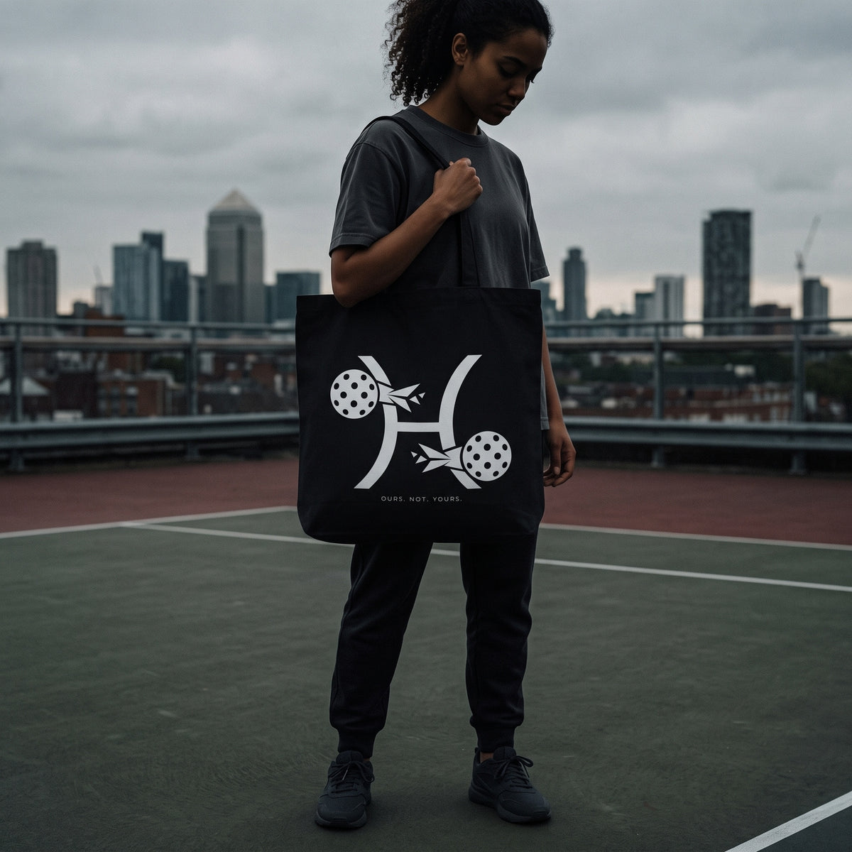 Pisces — Two Forces tote bag — model carrying the black organic cotton pickleball tote bag